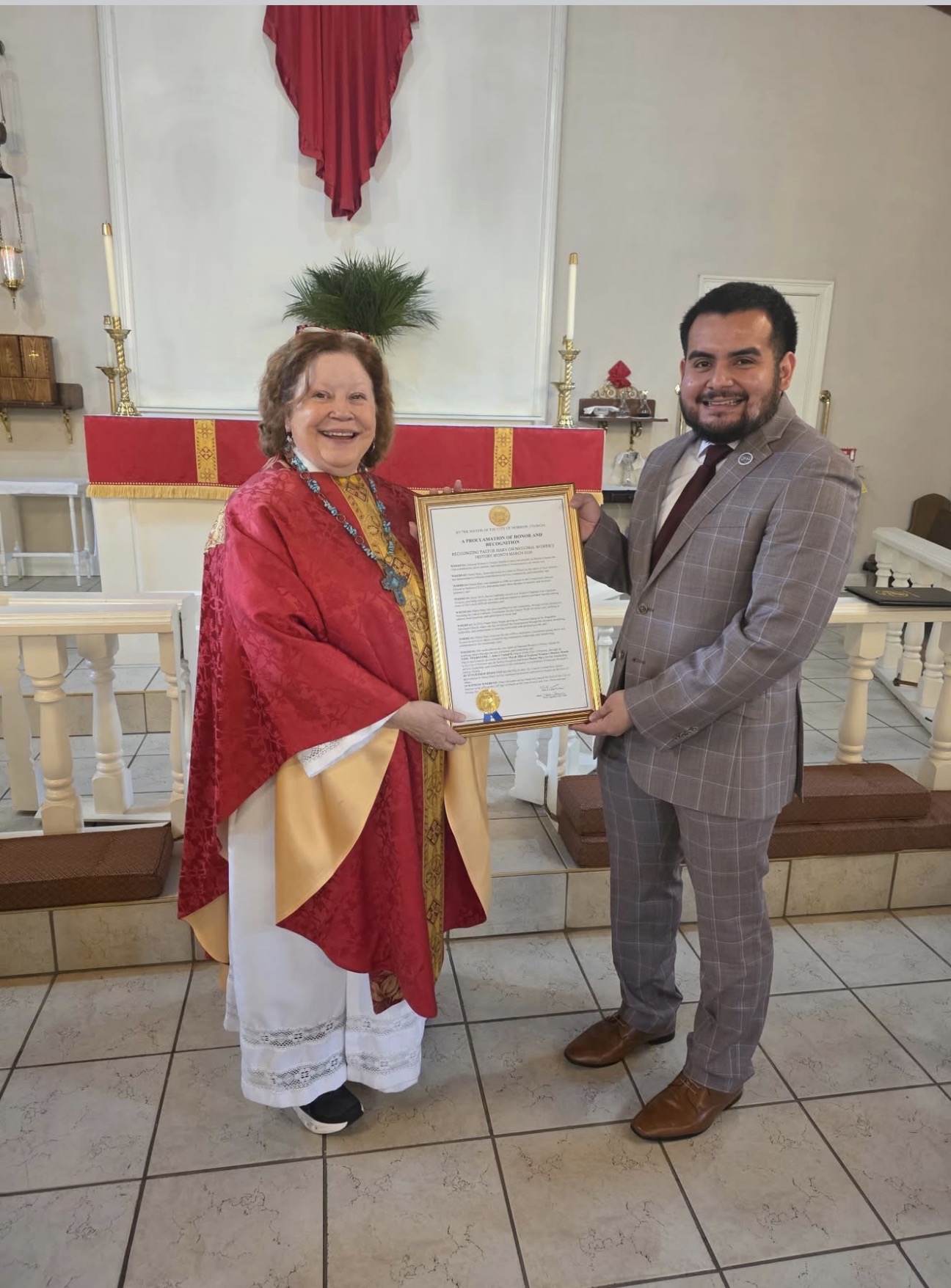 Mary Armstrong-Reiner receives a City of Morrow proclamation from Victor Aguilar at Saint Augustine of Canterbury Episcopal Church in Morrow.