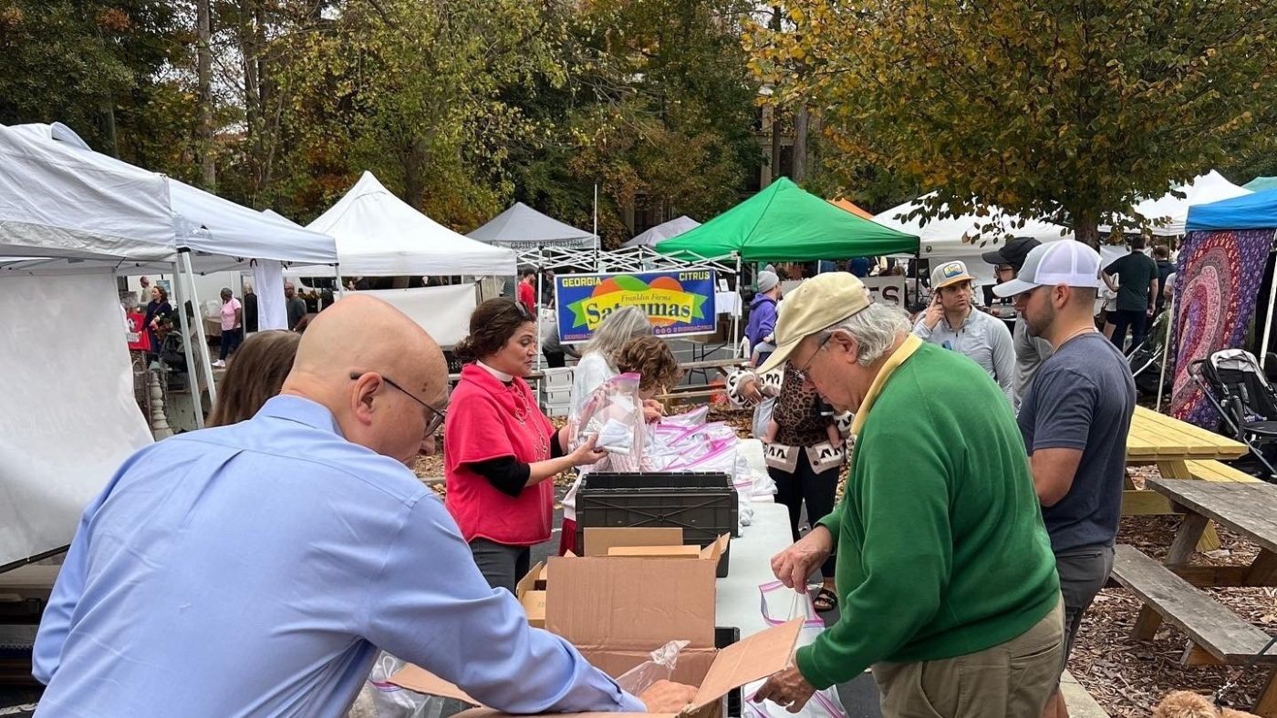 Volunteers prepare materials at Peachtree Road Farmers Market.