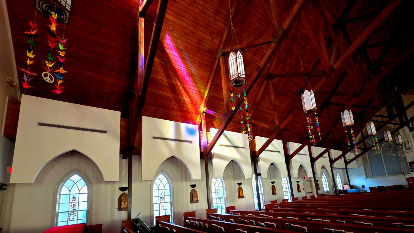 Colorful origami cranes hang from lanterns beneath the wooden ceiling at St. Matthew’s Episcopal Church in Snellville.